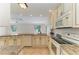 Well-equipped kitchen with granite counters, white cabinets, and stainless steel appliances at 645 Liberty St, Englewood, FL 34223