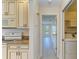 Kitchen with modern appliances and adjacent laundry room, all with updated flooring at 645 Liberty St, Englewood, FL 34223
