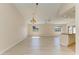 Spacious open-concept area featuring light wood-look flooring and updated lighting at 645 Liberty St, Englewood, FL 34223