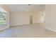 Open-concept living area with light wood-look flooring and neutral wall colors at 645 Liberty St, Englewood, FL 34223