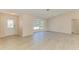 Bright living room with light wood-look flooring and bay window for natural light at 645 Liberty St, Englewood, FL 34223
