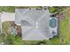 Birds eye view of a home with a screened-in pool and patio with table and chairs surrounded by green yard at 6552 Meandering Way, Lakewood Ranch, FL 34202