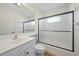 Bathroom with a sink, toilet, shower with glass doors, and black hardware at 6552 Meandering Way, Lakewood Ranch, FL 34202