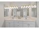 Well lit bathroom with double sinks, tile flooring, and an enclosed shower at 6552 Meandering Way, Lakewood Ranch, FL 34202
