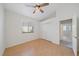 Comfortable bedroom featuring wood-look floors, closet, ceiling fan and open doorway at 6552 Meandering Way, Lakewood Ranch, FL 34202