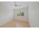 Bright bedroom with wood-look floors, a ceiling fan, and exterior window views at 6552 Meandering Way, Lakewood Ranch, FL 34202