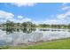 Scenic lake view reflecting the clouds above and the surrounding houses on a bright and sunny day at 6552 Meandering Way, Lakewood Ranch, FL 34202