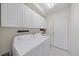 Convenient laundry room with washer, dryer, and storage cabinets at 6552 Meandering Way, Lakewood Ranch, FL 34202