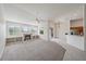 Open living room with fireplace and built in shelves overlooking the pool and lake at 6552 Meandering Way, Lakewood Ranch, FL 34202