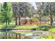 Colorful playground set near a pond, offering fun for all ages, with plenty of shade at 6552 Meandering Way, Lakewood Ranch, FL 34202