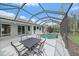 Outdoor screened-in pool area with a table and chairs perfect for entertaining or relaxing by the pool at 6552 Meandering Way, Lakewood Ranch, FL 34202