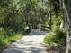 Scenic walking trail with a bridge, surrounded by lush greenery and mature trees at 6552 Meandering Way, Lakewood Ranch, FL 34202