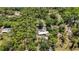 Aerial view of property with swimming pool surrounded by lush greenery and trees at 6990 Richardson Rd, Sarasota, FL 34240