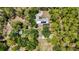 Aerial view of home on large lot surrounded by trees, showcasing pool and spacious layout at 6990 Richardson Rd, Sarasota, FL 34240