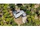 Aerial shot of a house with a metal roof, screened-in pool, and ample trees offering backyard privacy at 6990 Richardson Rd, Sarasota, FL 34240