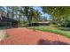 Expansive backyard with brick patio, mature trees, and storage building offers endless outdoor possibilities at 6990 Richardson Rd, Sarasota, FL 34240