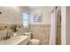 Well-lit bathroom with a decorative tile backsplash, neutral wall paint, and shower with curtain at 6990 Richardson Rd, Sarasota, FL 34240