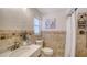 Cozy bathroom with tiled walls, shower, updated fixtures, and decorative sailboat art at 6990 Richardson Rd, Sarasota, FL 34240