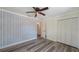 Bedroom featuring a ceiling fan, closet, blue and white wallpaper, and luxury vinyl plank flooring at 6990 Richardson Rd, Sarasota, FL 34240