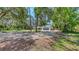 A spacious home with a three-car garage, nestled among mature trees, offering both privacy and accessibility at 6990 Richardson Rd, Sarasota, FL 34240