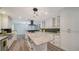 Expansive kitchen with white cabinets, stainless hood, large island, and a herringbone backsplash at 6990 Richardson Rd, Sarasota, FL 34240
