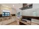 Kitchen boasts stainless appliances, a farmhouse sink, stone countertops, and black backsplash at 6990 Richardson Rd, Sarasota, FL 34240