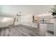 Open living area showcasing wood floors connecting to kitchen and sunroom with plenty of light at 6990 Richardson Rd, Sarasota, FL 34240