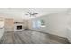 Spacious living room featuring a brick fireplace, built-in shelving, and large windows for natural light at 6990 Richardson Rd, Sarasota, FL 34240