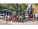 Outdoor dining scene with tables and chairs, highlighting the vibrant street atmosphere and the outdoor space at 6990 Richardson Rd, Sarasota, FL 34240