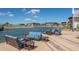Comfortable outdoor seating area with stylish blue patio furniture, offering a relaxing waterfront view at 6990 Richardson Rd, Sarasota, FL 34240