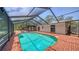 Screened-in pool area with brick patio, perfect for outdoor relaxation and entertaining at 6990 Richardson Rd, Sarasota, FL 34240