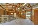 Rustic interior with a concrete floor, wooden beams, and an open doorway at 6990 Richardson Rd, Sarasota, FL 34240