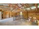 Rustic interior with a concrete floor, wooden beams, and an open doorway at 6990 Richardson Rd, Sarasota, FL 34240
