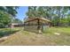 Outdoor shed with a fenced yard with mature trees in the background at 6990 Richardson Rd, Sarasota, FL 34240