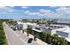 Street view showcasing a modern building with Cooper's Hawk Restaurant, lush trees, and ample parking at 6990 Richardson Rd, Sarasota, FL 34240