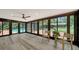 Enclosed sunroom with a view of the pool through large windows and stylish furniture at 6990 Richardson Rd, Sarasota, FL 34240