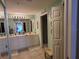 Bright bathroom featuring double vanity sinks, tile floor, and shower at 7273 Cedar Hollow Cir # 102, Bradenton, FL 34203