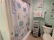 Well-kept bathroom featuring a shower and a variety of beach themed decor for a warm, inviting look at 7273 Cedar Hollow Cir # 102, Bradenton, FL 34203