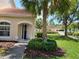Inviting home exterior featuring a well-manicured lawn, palm trees, and community pool access at 7273 Cedar Hollow Cir # 102, Bradenton, FL 34203
