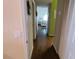 Hallway featuring hardwood floors and neutral paint that connect the living area to the bedrooms at 7273 Cedar Hollow Cir # 102, Bradenton, FL 34203