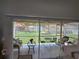 Screened-in lanai featuring a ceiling fan, comfortable seating, and a view of the manicured backyard at 7273 Cedar Hollow Cir # 102, Bradenton, FL 34203