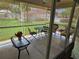 Screened-in lanai featuring a table and chairs, comfortable seating, and view of the green backyard at 7273 Cedar Hollow Cir # 102, Bradenton, FL 34203