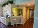 Open living space with a kitchen view, a breakfast bar, and modern decor at 7273 Cedar Hollow Cir # 102, Bradenton, FL 34203