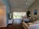 Bright living room featuring vaulted ceiling, hardwood floors and sliding door access to the screened-in lanai at 7273 Cedar Hollow Cir # 102, Bradenton, FL 34203