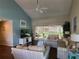 Comfortable living room with large windows and view to screened porch and community at 7273 Cedar Hollow Cir # 102, Bradenton, FL 34203