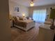 Cozy main bedroom with plush carpet, ceiling fan, and plenty of natural light from the window at 7273 Cedar Hollow Cir # 102, Bradenton, FL 34203
