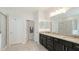 A spacious bathroom features a double vanity, framed mirrors, and separate toilet and shower rooms at 7379 47Th Avenue E Cir, Bradenton, FL 34203