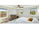 Bright bedroom with three large windows, a ceiling fan, and a wooden dresser at 7379 47Th Avenue E Cir, Bradenton, FL 34203