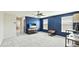 This bonus room features a large window, ceiling fan, and a relaxing blue accent wall at 7379 47Th Avenue E Cir, Bradenton, FL 34203