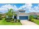 Charming two-story home boasts a well-manicured lawn, lush landscaping, and a two-car garage at 7379 47Th Avenue E Cir, Bradenton, FL 34203
